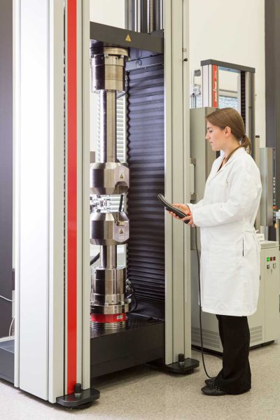 woman in lab coat examining machine